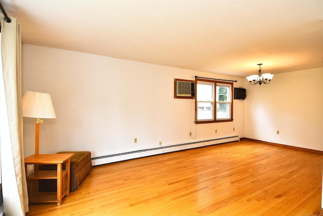 46 Millis St, Hamden, CT 06514 - unfurnished room with a baseboard heating unit, light wood-type flooring, a chandelier, and a wall mounted AC