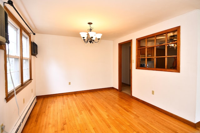 46 Millis St, Hamden, CT 06514 - spare room with baseboard heating, a chandelier, and light wood-style floors