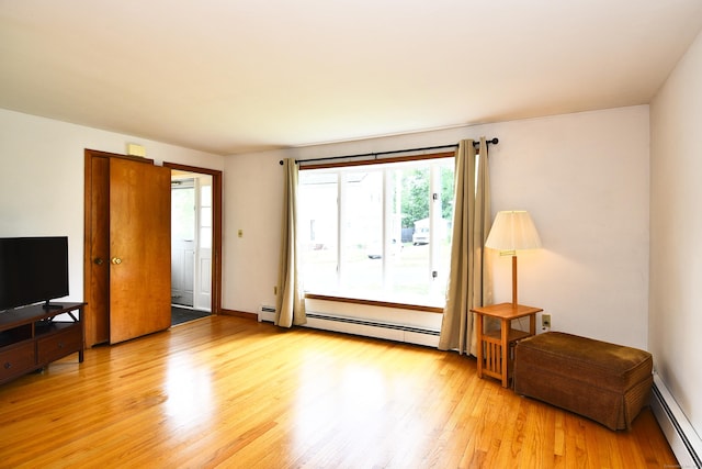 46 Millis St, Hamden, CT 06514 - living area with a baseboard heating unit and light wood-style floors