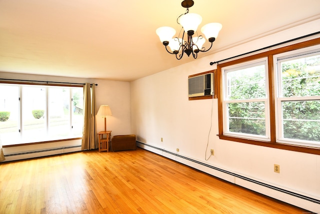 46 Millis St, Hamden, CT 06514 - empty room featuring a baseboard radiator, a chandelier, light wood-style floors, and an AC wall unit