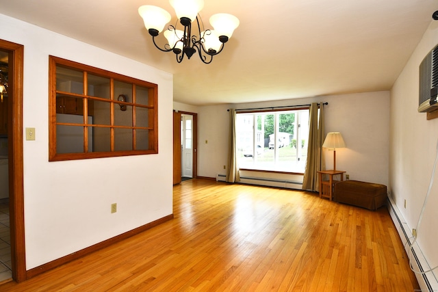 46 Millis St, Hamden, CT 06514 - empty room featuring a baseboard radiator, a chandelier, and light wood finished floors