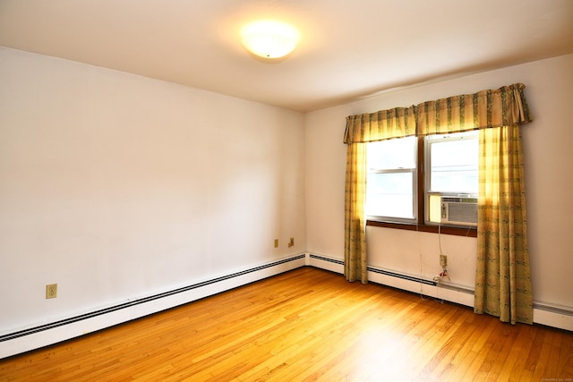 46 Millis St, Hamden, CT 06514 - empty room with light wood-style floors and a baseboard heating unit