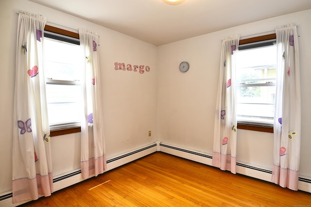 46 Millis St, Hamden, CT 06514 - spare room featuring healthy amount of natural light, light wood finished floors, and a baseboard heating unit