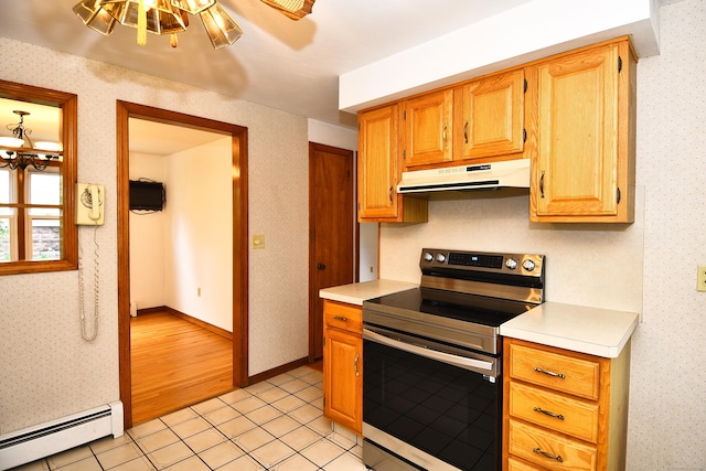 46 Millis St, Hamden, CT 06514 - kitchen featuring stainless steel electric range oven, a baseboard radiator, under cabinet range hood, light countertops, and light tile patterned floors