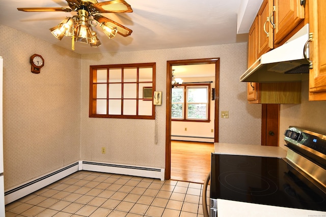 46 Millis St, Hamden, CT 06514 - kitchen with stainless steel electric stove, a baseboard heating unit, wallpapered walls, under cabinet range hood, and a ceiling fan