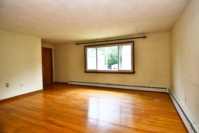 46 Millis St, Hamden, CT 06514 - unfurnished room featuring a baseboard heating unit and light wood-style floors