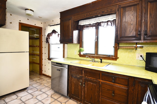 46 Millis St, Hamden, CT 06514 - kitchen with freestanding refrigerator, stainless steel dishwasher, black microwave, light countertops, and wallpapered walls