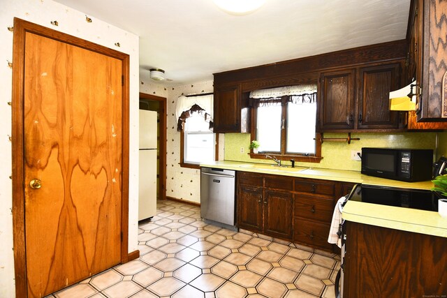 46 Millis St, Hamden, CT 06514 - kitchen with dishwasher, black microwave, freestanding refrigerator, light countertops, and wallpapered walls