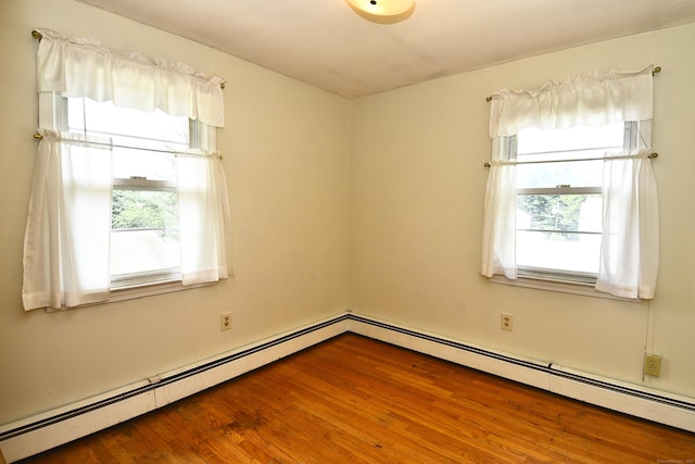 46 Millis St, Hamden, CT 06514 - unfurnished room with a baseboard heating unit and wood finished floors
