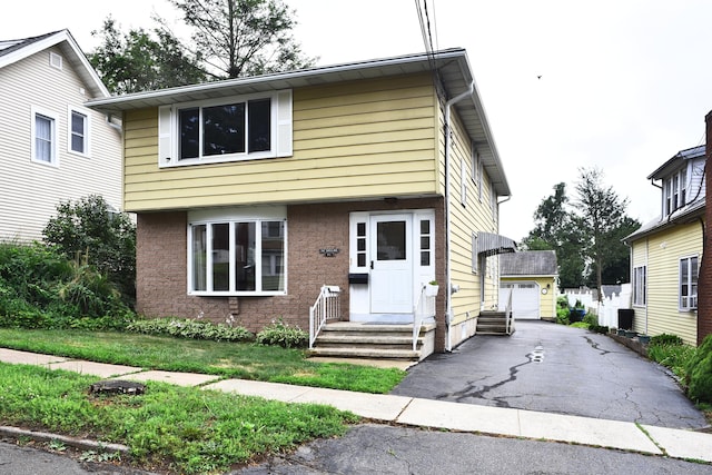 46 Millis St, Hamden, CT 06514 - view of front of home featuring a detached garage, an outdoor structure, driveway, and entry steps