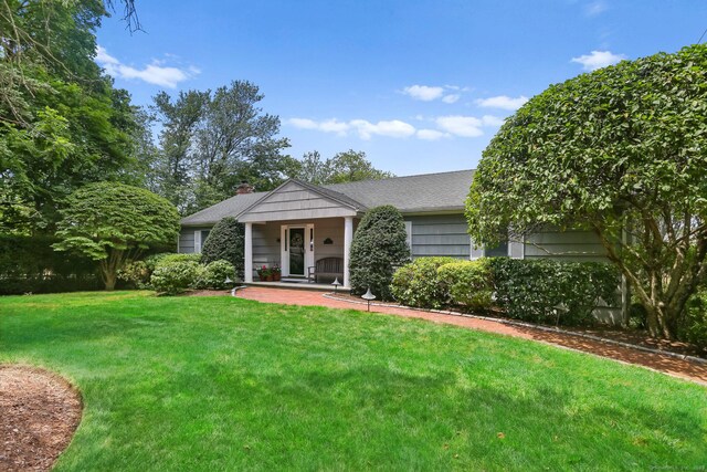 78 Kings Hwy S, Westport, CT 06880 - view of front of home with a front lawn, a chimney, and covered porch