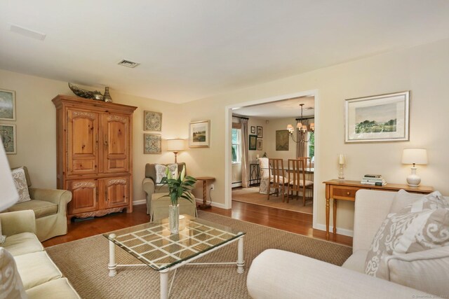 78 Kings Hwy S, Westport, CT 06880 - living room featuring a chandelier, wood finished floors, and baseboard heating