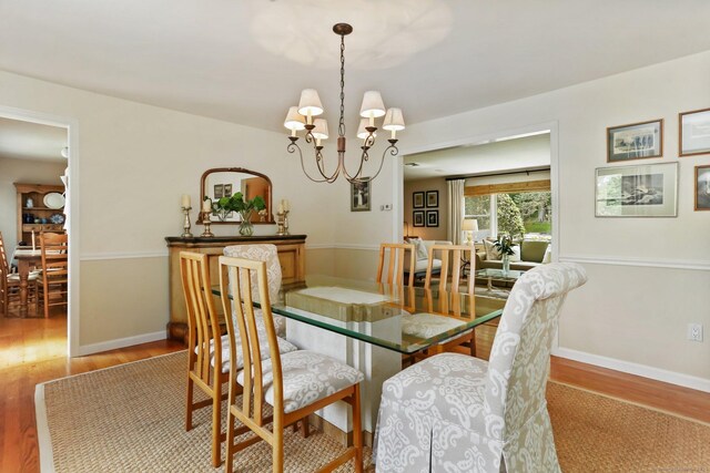 78 Kings Hwy S, Westport, CT 06880 - dining room with light wood-style flooring and a chandelier