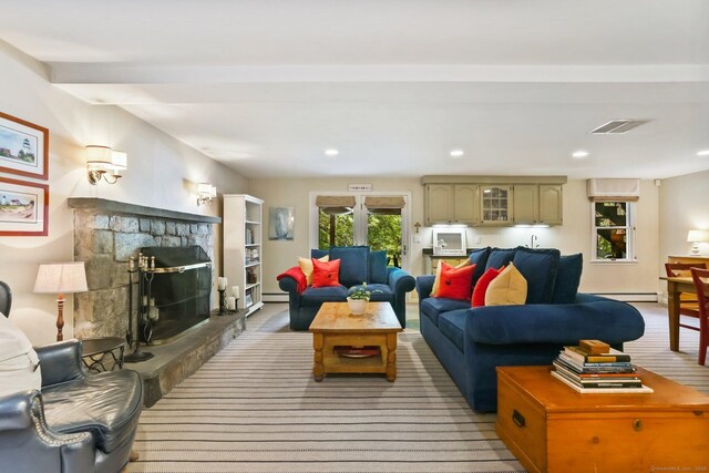 78 Kings Hwy S, Westport, CT 06880 - living room with baseboard heating, a baseboard radiator, a stone fireplace, and recessed lighting