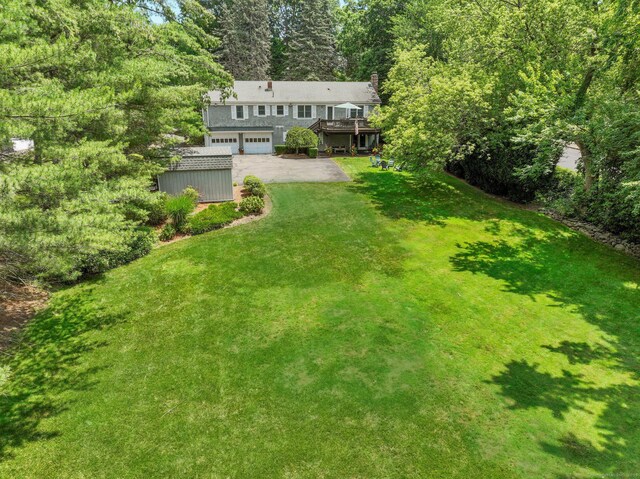 78 Kings Hwy S, Westport, CT 06880 - view of green lawn with a wooden deck, driveway, and an attached garage