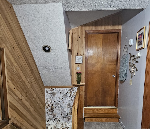 33 Tanner Ave, Norwich, CT 06360 - doorway to outside featuring vaulted ceiling, carpet floors, and wooden walls