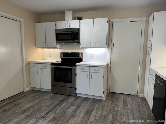 4 Heritage Crst Unit A, Southbury, CT 06488 - kitchen featuring stainless steel appliances, dark wood-style floors, light countertops, and white cabinetry