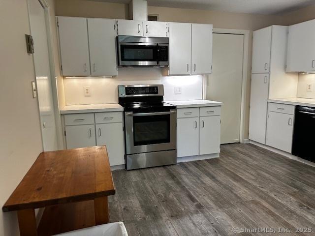 4 Heritage Crst Unit A, Southbury, CT 06488 - kitchen featuring stainless steel appliances, light countertops, dark wood-style flooring, and white cabinetry