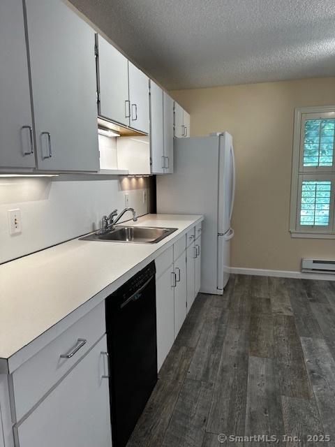 4 Heritage Crst Unit A, Southbury, CT 06488 - kitchen with black dishwasher, dark wood-type flooring, a textured ceiling, light countertops, and white cabinetry