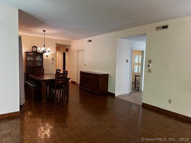 4 Heritage Crst Unit A, Southbury, CT 06488 - dining area featuring a chandelier and baseboards