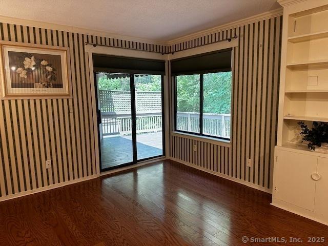 4 Heritage Crst Unit A, Southbury, CT 06488 - unfurnished room with dark wood-style floors, built in shelves, and ornamental molding