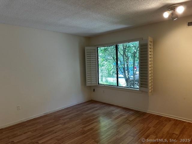 4 Heritage Crst Unit A, Southbury, CT 06488 - unfurnished room with wood finished floors and a textured ceiling