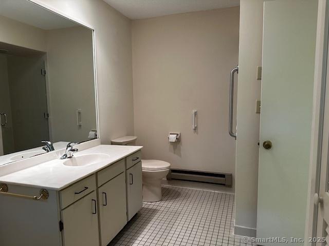 4 Heritage Crst Unit A, Southbury, CT 06488 - full bath featuring baseboard heating, vanity, and tile patterned floors
