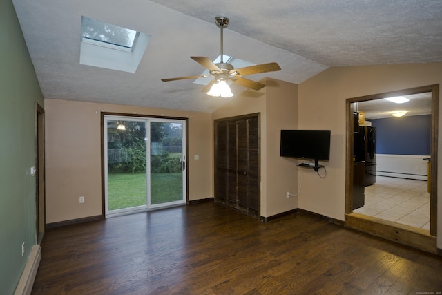 4 Birchwood Ter, Enfield, CT 06082 - unfurnished living room with a baseboard radiator, a skylight, dark wood-style flooring, vaulted ceiling, and a ceiling fan