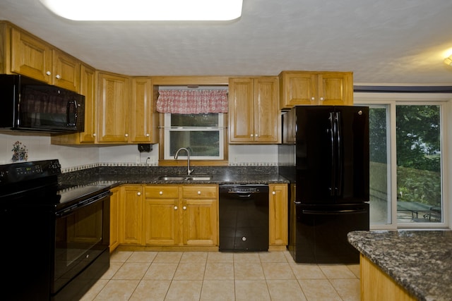 4 Birchwood Ter, Enfield, CT 06082 - kitchen featuring black appliances, light tile patterned floors, dark stone counters, and brown cabinets