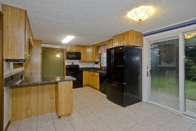 4 Birchwood Ter, Enfield, CT 06082 - kitchen with black appliances, a peninsula, light tile patterned floors, and dark stone countertops