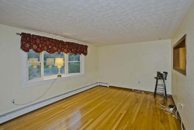 4 Birchwood Ter, Enfield, CT 06082 - unfurnished room with a baseboard heating unit, a textured ceiling, and wood finished floors