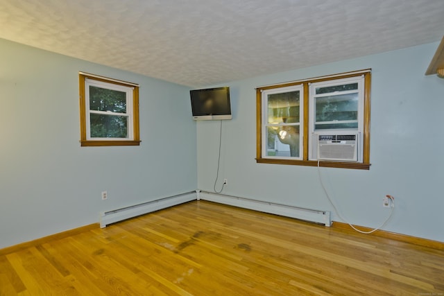 4 Birchwood Ter, Enfield, CT 06082 - unfurnished room featuring a baseboard heating unit, wood finished floors, cooling unit, and a textured ceiling
