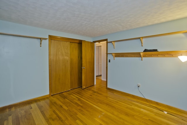 4 Birchwood Ter, Enfield, CT 06082 - unfurnished bedroom with wood finished floors and a textured ceiling