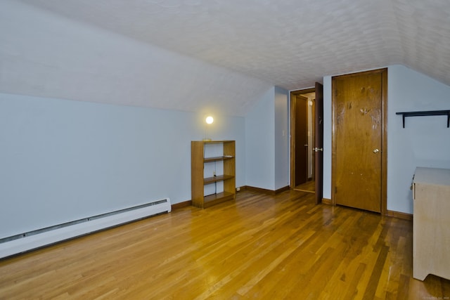 4 Birchwood Ter, Enfield, CT 06082 - bonus room featuring a baseboard radiator, wood finished floors, and lofted ceiling