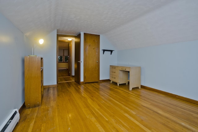 4 Birchwood Ter, Enfield, CT 06082 - additional living space featuring baseboard heating, wood finished floors, vaulted ceiling, and a textured ceiling