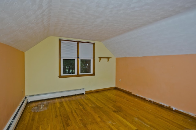 4 Birchwood Ter, Enfield, CT 06082 - bonus room with baseboard heating, wood finished floors, lofted ceiling, and a textured ceiling