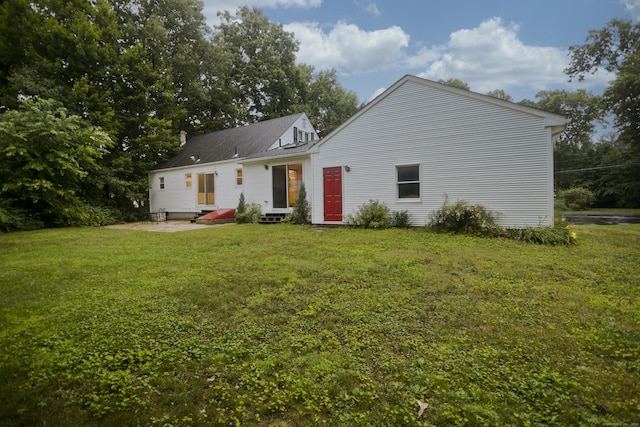 4 Birchwood Ter, Enfield, CT 06082 - back of property with a lawn, entry steps, and a chimney