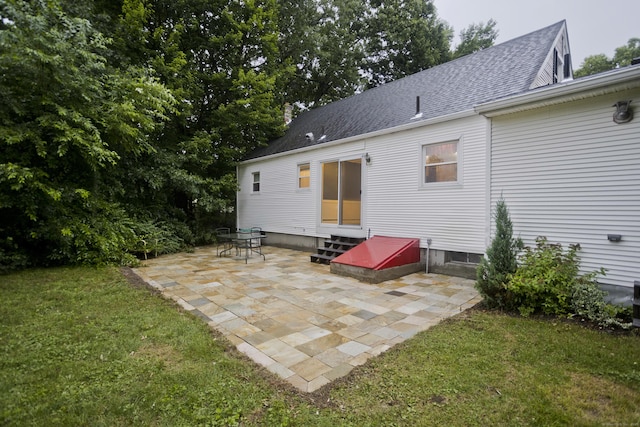 4 Birchwood Ter, Enfield, CT 06082 - back of property featuring entry steps, a patio area, a yard, and a shingled roof