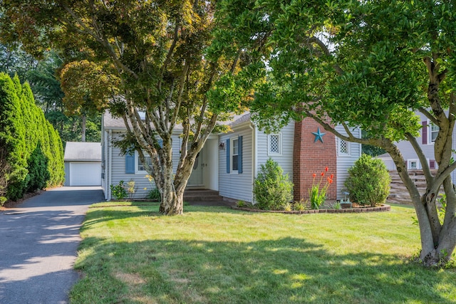 44 Durwin St, Middletown, CT 06457 - view of property hidden behind natural elements with an outbuilding, a front yard, and a detached garage