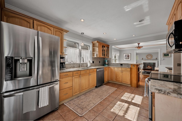 44 Durwin St, Middletown, CT 06457 - kitchen featuring appliances with stainless steel finishes, a peninsula, ornamental molding, decorative backsplash, and light tile patterned floors