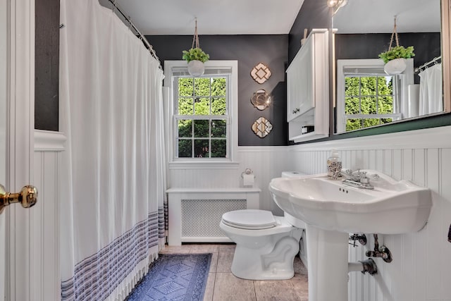 44 Durwin St, Middletown, CT 06457 - bathroom with radiator heating unit, a wainscoted wall, tile patterned flooring, and a shower with shower curtain