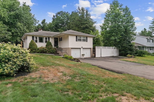 1762 Waterbury Rd, Cheshire, CT 06410 - view of front of home featuring an attached garage, a chimney, asphalt driveway, and a front yard