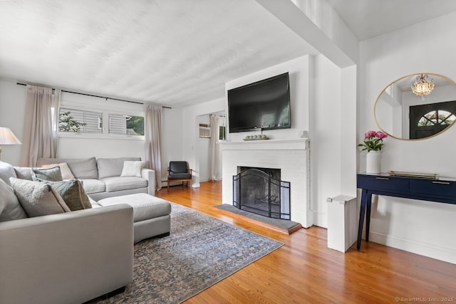 1762 Waterbury Rd, Cheshire, CT 06410 - living room with wood finished floors and a brick fireplace