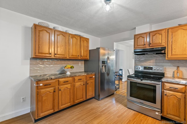 1762 Waterbury Rd, Cheshire, CT 06410 - kitchen featuring appliances with stainless steel finishes, under cabinet range hood, light wood-style flooring, a textured ceiling, and brown cabinetry