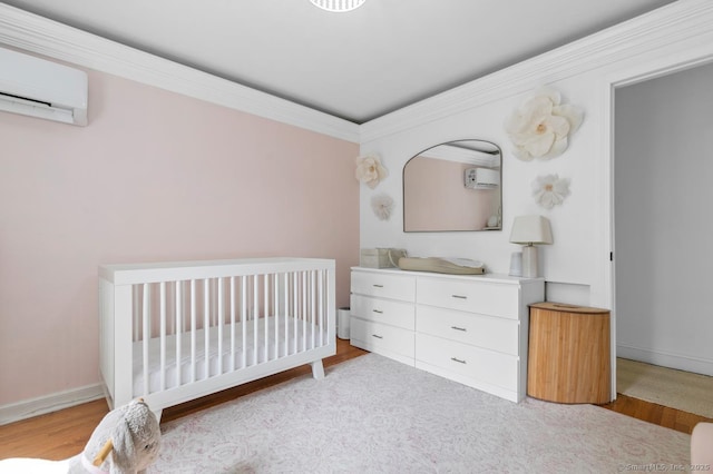 1762 Waterbury Rd, Cheshire, CT 06410 - bedroom featuring a wall mounted air conditioner, wood finished floors, a crib, a wall unit AC, and crown molding