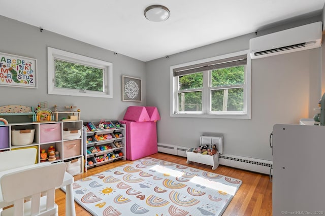1762 Waterbury Rd, Cheshire, CT 06410 - playroom featuring a wall mounted air conditioner, wood finished floors, and a baseboard heating unit