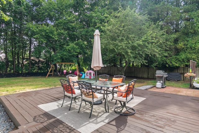 1762 Waterbury Rd, Cheshire, CT 06410 - deck featuring a fenced backyard, grilling area, outdoor dining space, a playground, and view of wooded area