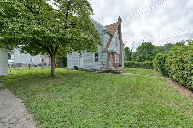 7 Ellsworth St, East Hartford, CT 06108 - view of home's exterior featuring a chimney and a yard