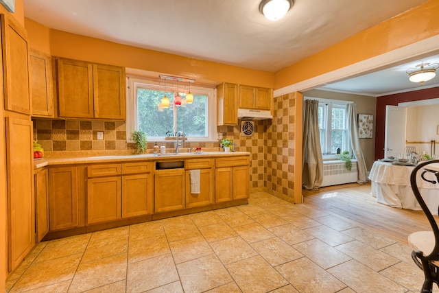 7 Ellsworth St, East Hartford, CT 06108 - kitchen featuring brown cabinetry, light countertops, radiator heating unit, and ornamental molding