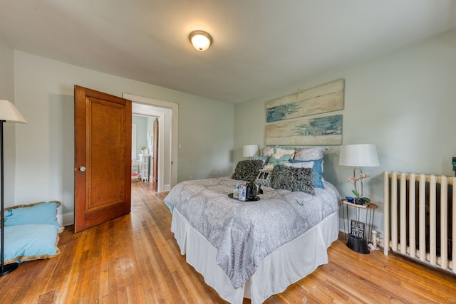 7 Ellsworth St, East Hartford, CT 06108 - bedroom with radiator heating unit and hardwood / wood-style floors